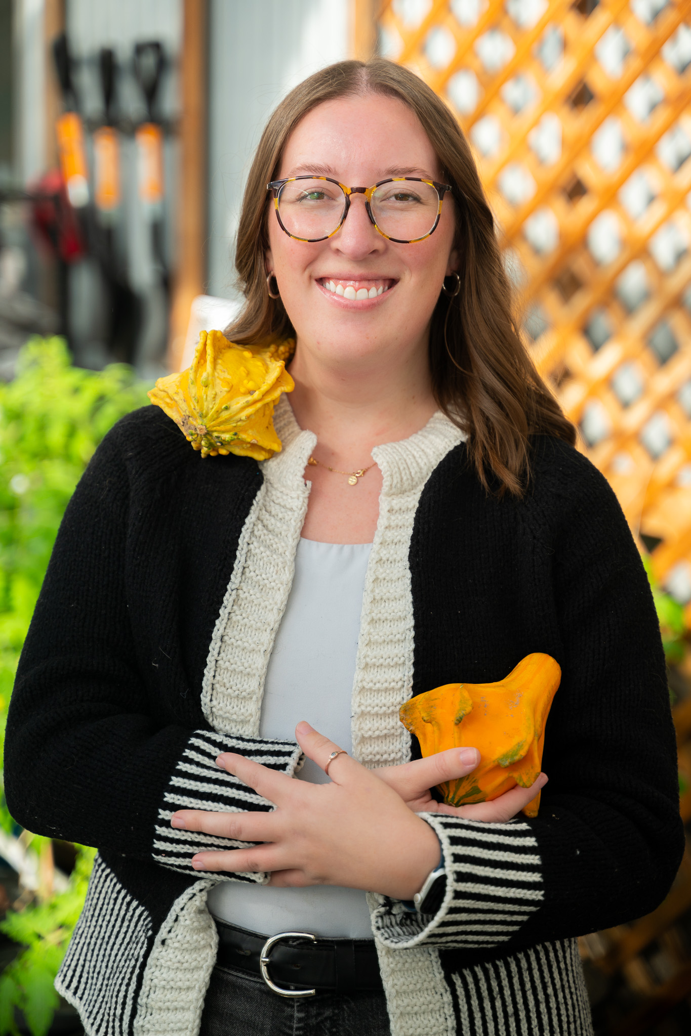 Madison's headshot cradling a gourd in her arms and one resting on her shoulder.