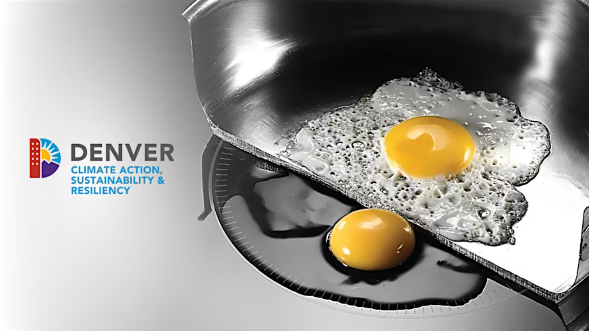 Stainless steel pan, that is cut in half down the middle, sits on an electric burner. A fried egg is in the pan and on the stove.