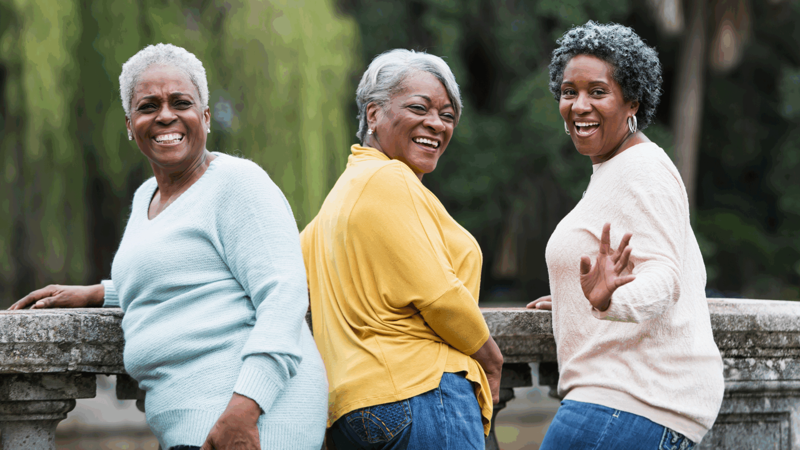 Senior black women waving