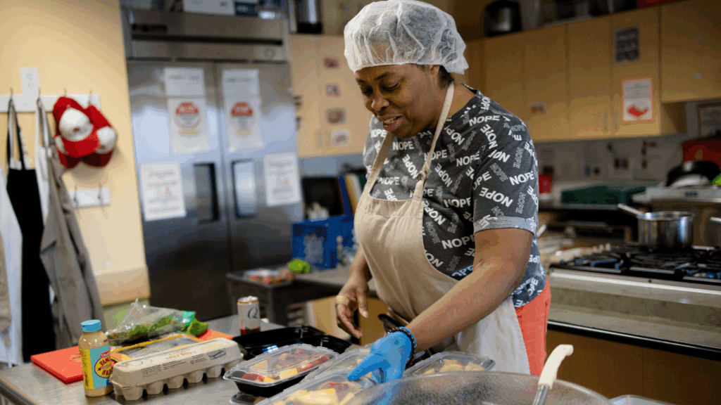 Black woman cooking in a commercial kitchen