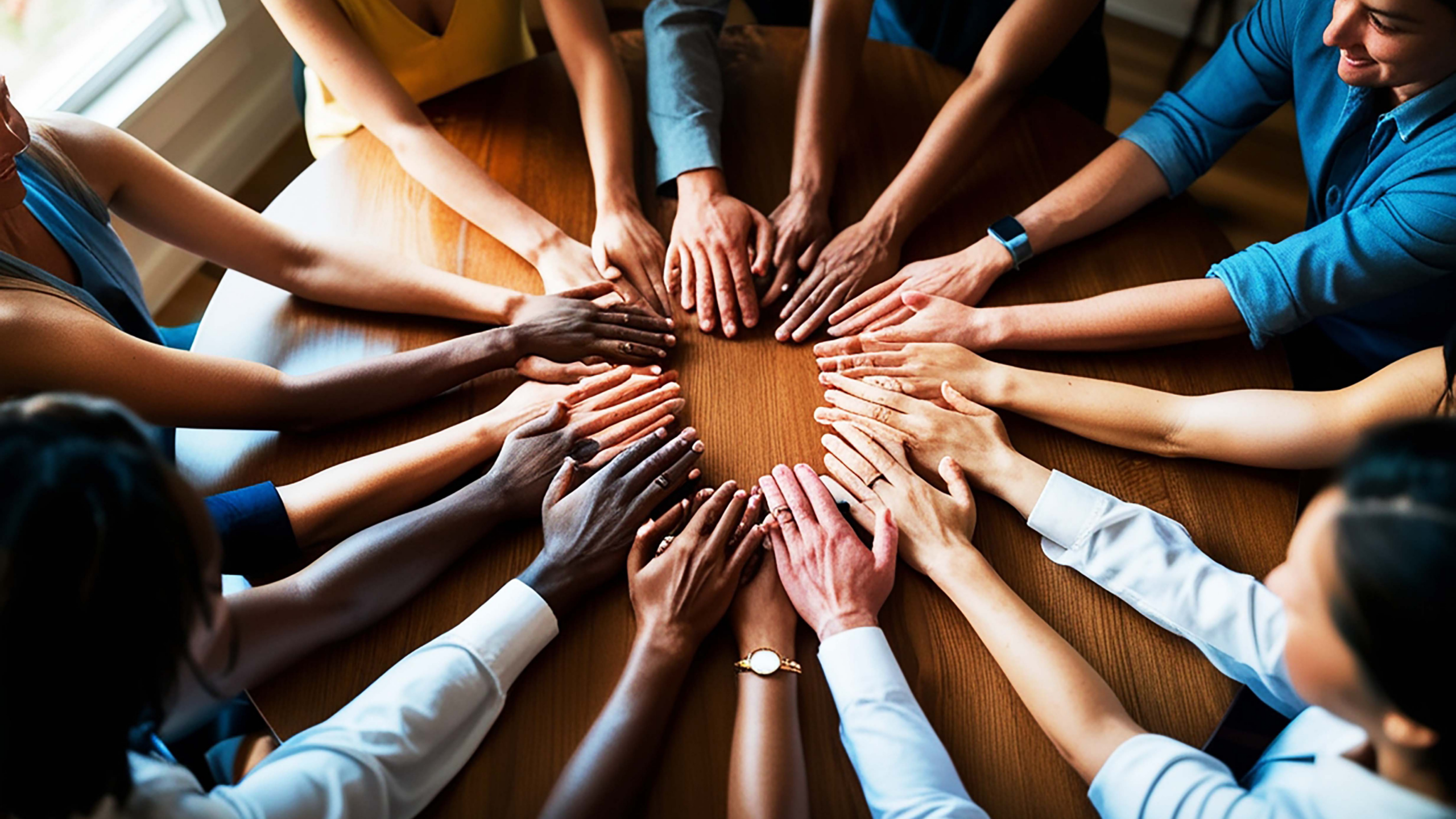 diverse hands united in collaboration on a table